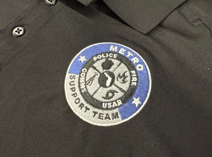 Black tactical polo with embroidered support-team patch
