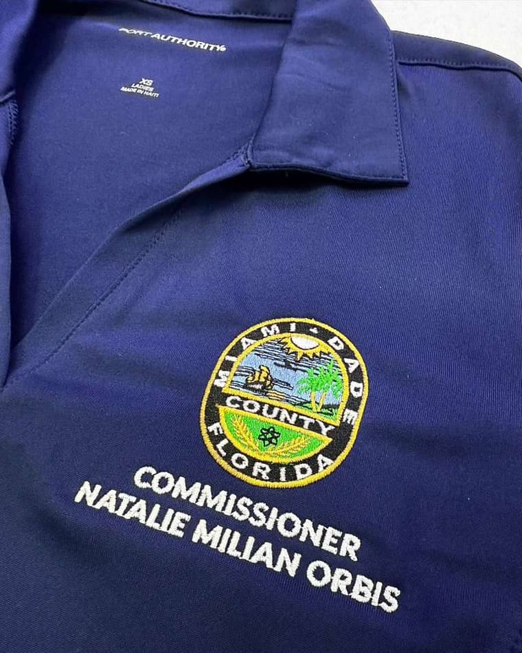 Navy uniform polo with embroidered county seal and lettering